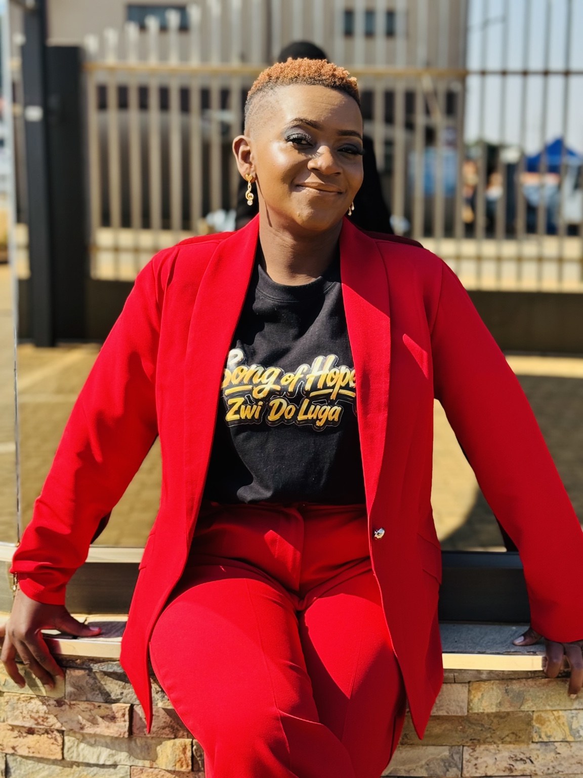 Newie in a red suit and Song of Hope T-shirt